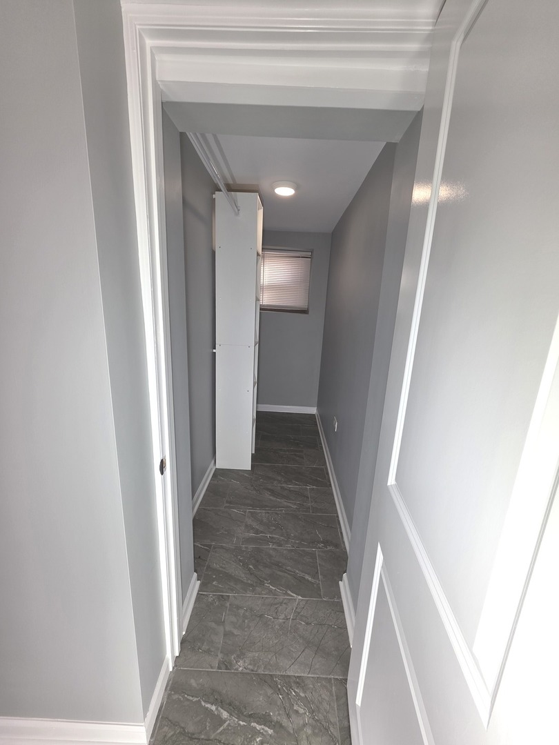 5134 West Henderson Street, Unit G Chicago, IL 60641 - Photo 16 of 47 a view of a hallway with wooden floor and staircase