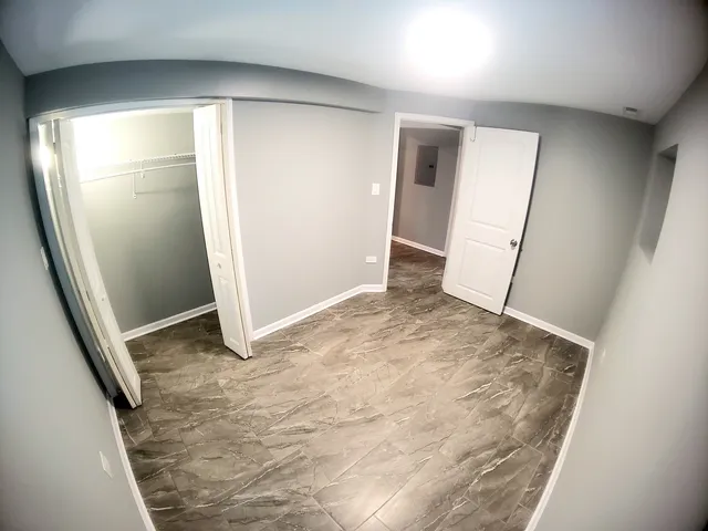 a bathroom with a granite countertop sink a toilet a mirror and shower