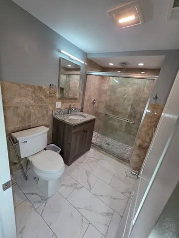 a view of a hallway to a livingroom with furniture