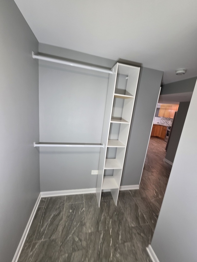 5134 West Henderson Street, Unit G Chicago, IL 60641 - Photo 37 of 47 a view of walk in closet with empty racks