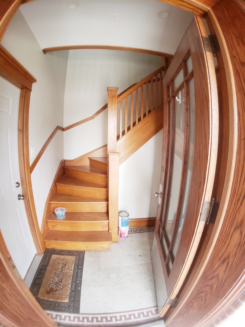 5134 West Henderson Street, Unit G Chicago, IL 60641 - Photo 4 of 47 a view of staircase with white walls and a window
