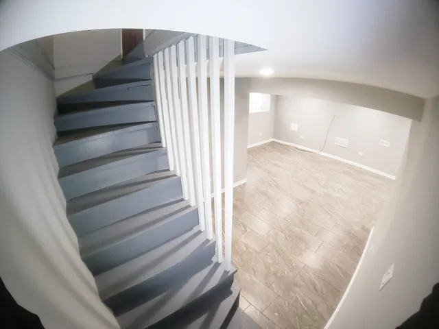 a view of a hallway with wooden floor and entryway