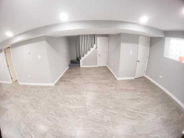 a kitchen with stainless steel appliances granite countertop a refrigerator a stove and a sink