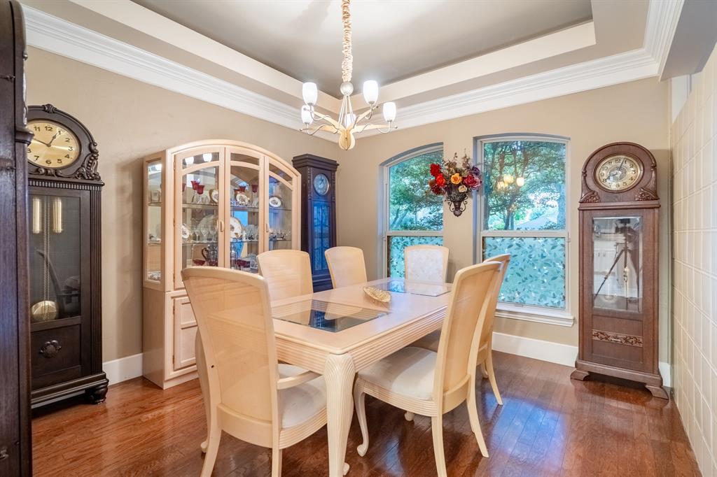 1450 Meandering Way Rockwall, TX 75087 - Photo 11 of 32 a view of a dining room with furniture wooden floor and chandelier