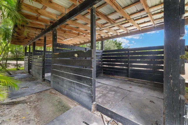 a kitchen with stainless steel appliances granite countertop a stove a sink a dining table and chairs with wooden floor