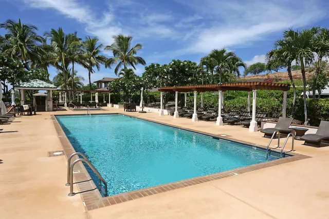 a view of a house with swimming pool and sitting area