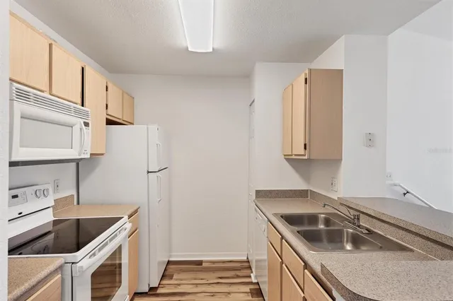 a kitchen that has a sink and a stove