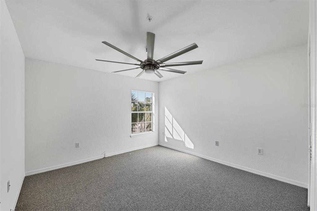8932 Manor Loop, Unit 207 Lakewood Ranch, FL 34202 - Photo 15 of 33 an empty room with windows and fan