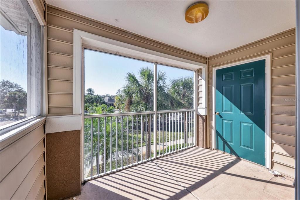 8932 Manor Loop, Unit 207 Lakewood Ranch, FL 34202 - Photo 19 of 33 a view of a balcony with wooden floor