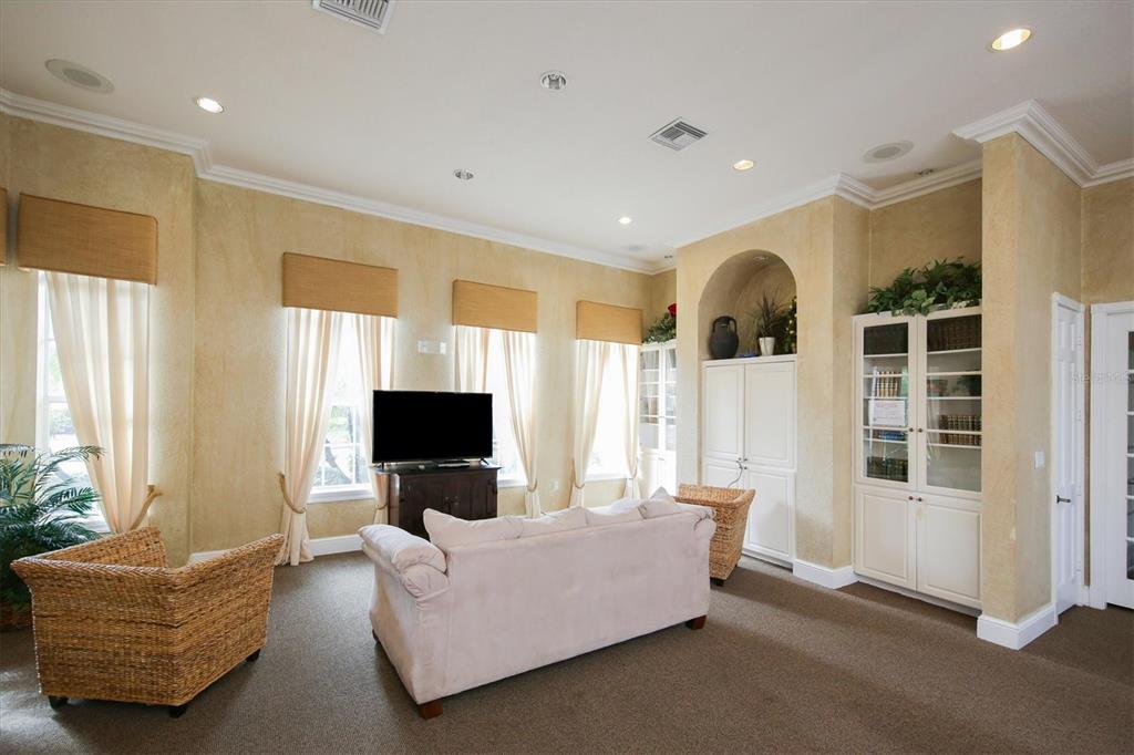 8932 Manor Loop, Unit 207 Lakewood Ranch, FL 34202 - Photo 25 of 33 a living room with furniture and flat screen tv