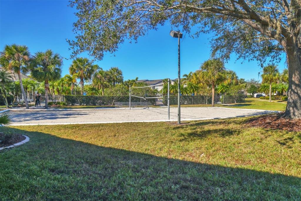 8932 Manor Loop, Unit 207 Lakewood Ranch, FL 34202 - Photo 31 of 33 a swimming pool with trees in the background