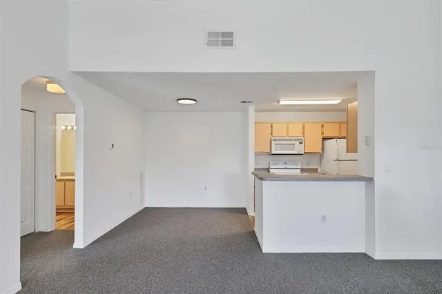 a kitchen with granite countertop a sink and a refrigerator