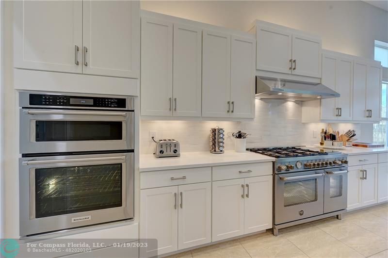 1000 Hookline Circle Loxahatchee, FL 33470 - Photo 14 of 98 a kitchen with cabinets stainless steel appliances and a wooden floors