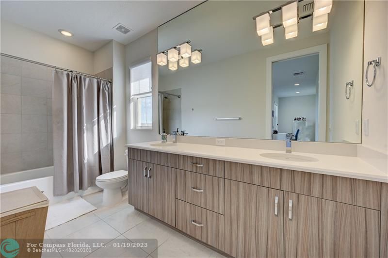 1000 Hookline Circle Loxahatchee, FL 33470 - Photo 49 of 98 a bathroom with a sink a toilet a mirror and shower