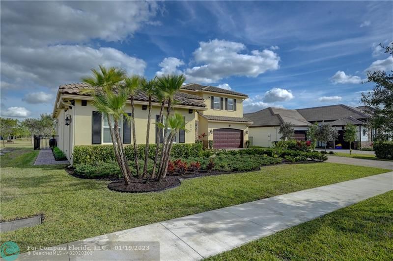 1000 Hookline Circle Loxahatchee, FL 33470 - Photo 5 of 98 a front view of a house with garden