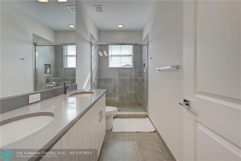 1000 Hookline Circle Loxahatchee, FL 33470 - Photo 57 of 98 a bathroom with a granite countertop sink a toilet a mirror and shower