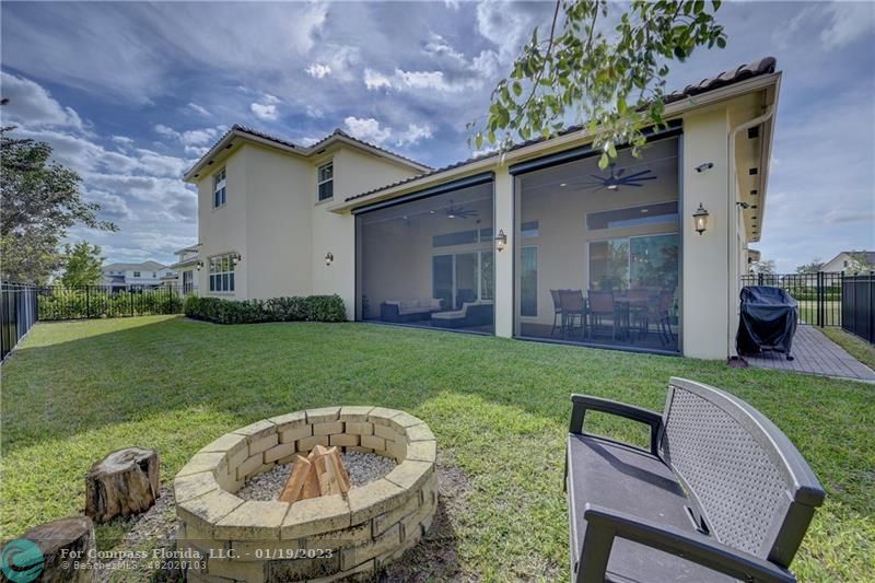 1000 Hookline Circle Loxahatchee, FL 33470 - Photo 66 of 98 a backyard of a house with table and chairs