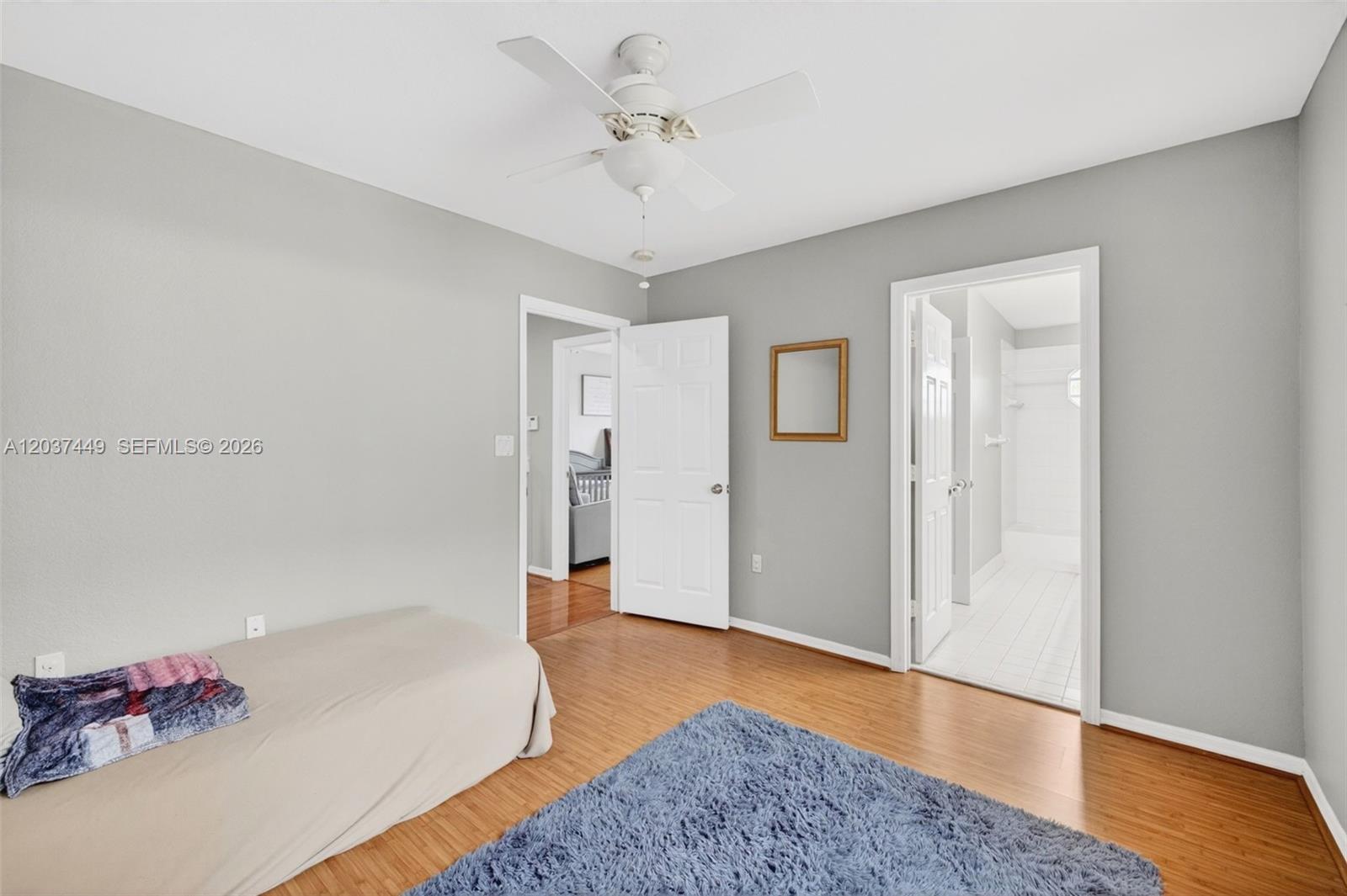 17488 Southwest 28th Court Miramar, FL 33029 - Photo 30 of 50 a spacious bedroom with a bed and a chandelier