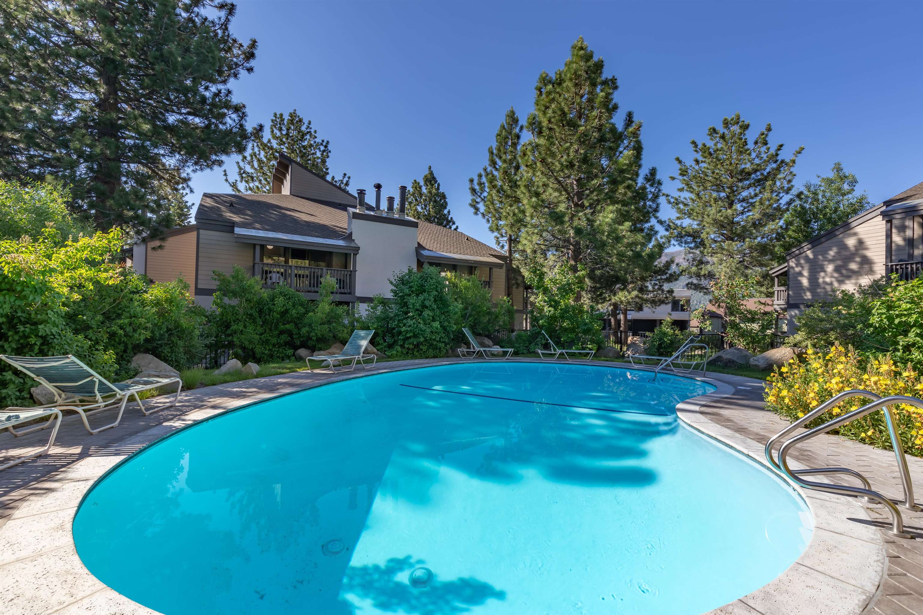 362 Old Mammoth Road, Unit 58 Mammoth Lakes, CA 93546 - Photo 21 of 26 a view of a swimming pool with a yard