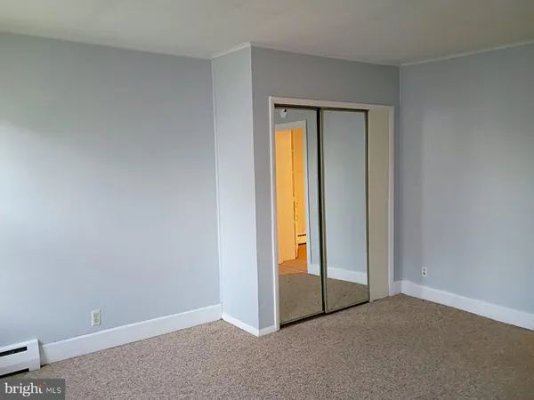 a view of an empty room and a window