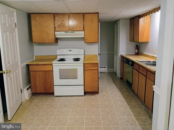 a kitchen with a stove top oven sink and cabinets