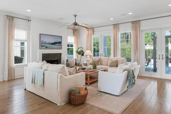 a living room with patio furniture and a large window