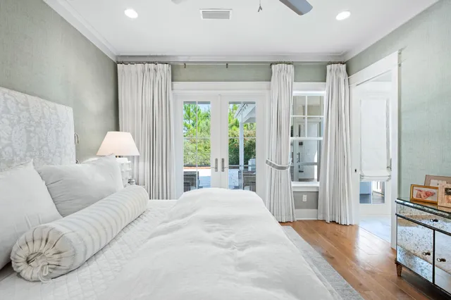 a view of a house with brick walls and a yard with plants