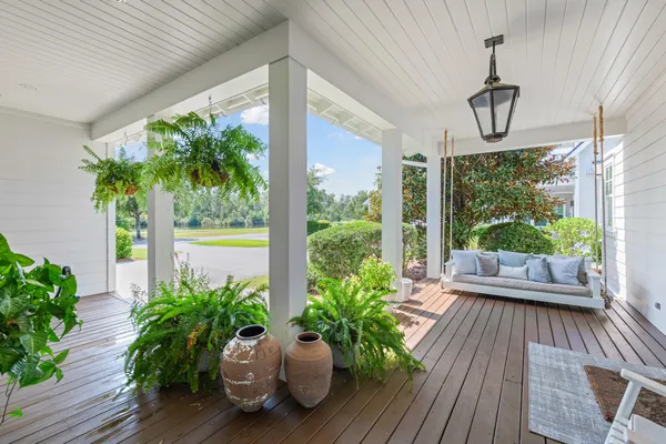 a kitchen with stainless steel appliances granite countertop a stove a refrigerator a kitchen island a table and chairs