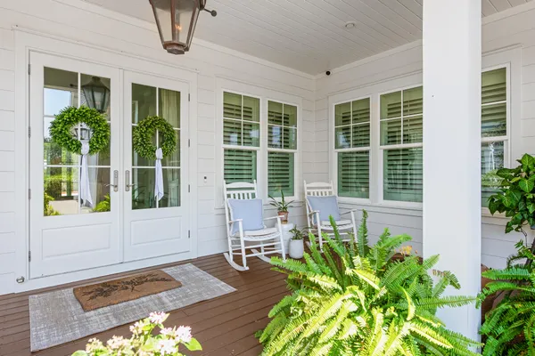 a kitchen with stainless steel appliances granite countertop a table chairs refrigerator and wooden floor