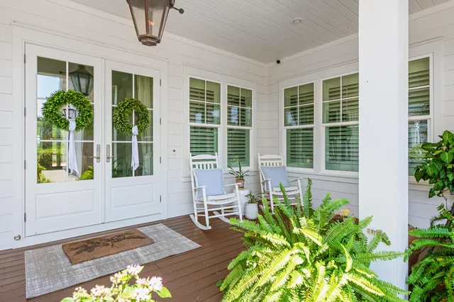 a kitchen with stainless steel appliances granite countertop a table chairs refrigerator and wooden floor