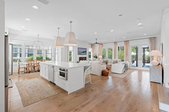 a living room with furniture a large window and a fireplace