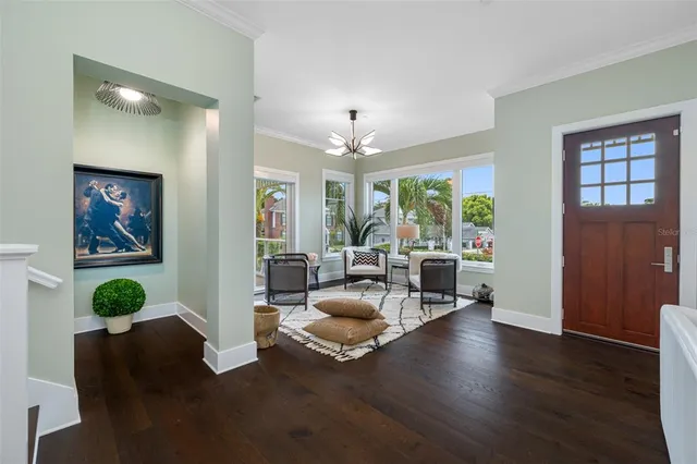 a kitchen that has a lot of cabinets in it and wooden floors