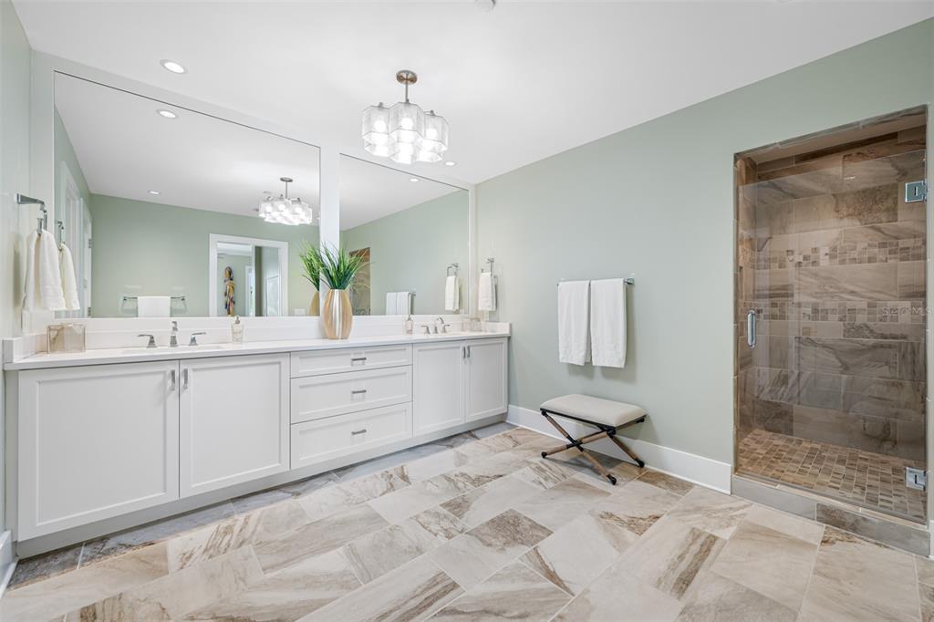 6 Hibiscus Lane Belleair, FL 33756 - Photo 43 of 65 a spacious bathroom with a double vanity sink a mirror and a shower