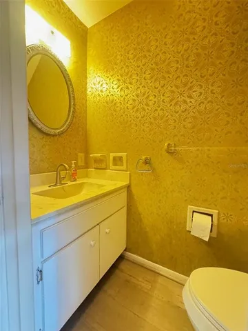 a bathroom with a sink mirror vanity and toilet