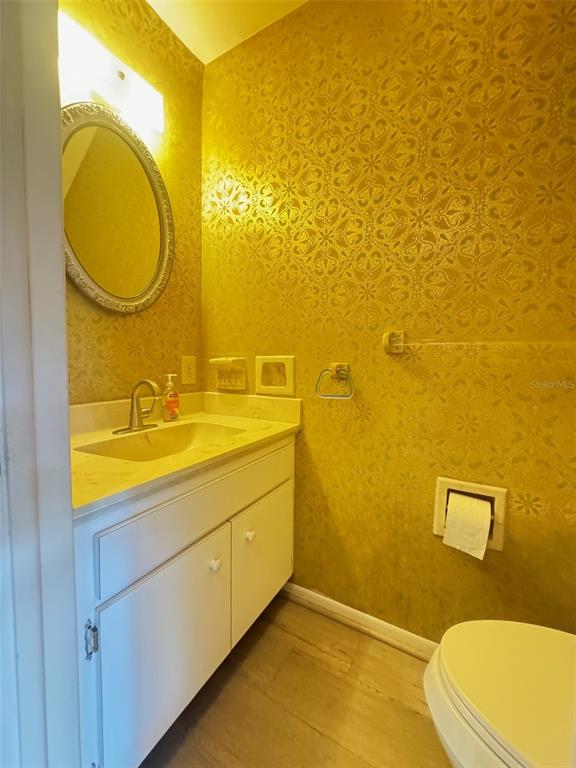 210 Elliot Avenue, Unit 135 Sarasota, FL 34232 - Photo 11 of 26 a bathroom with a sink mirror vanity and toilet