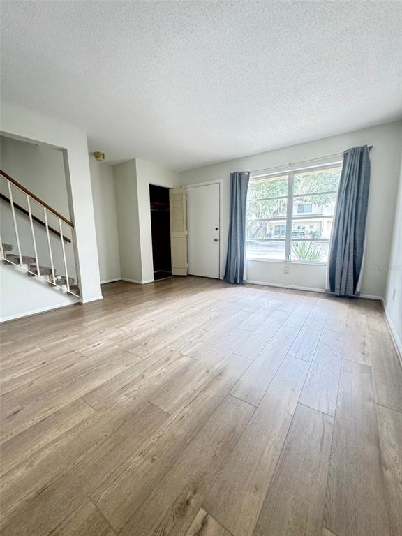 210 Elliot Avenue, Unit 135 Sarasota, FL 34232 - Photo 14 of 26 a view of an empty room with wooden floor and a window