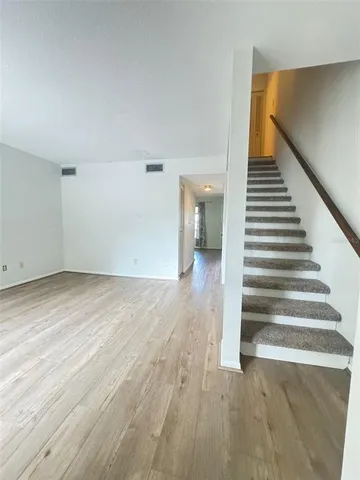 a view of an entryway with wooden floor
