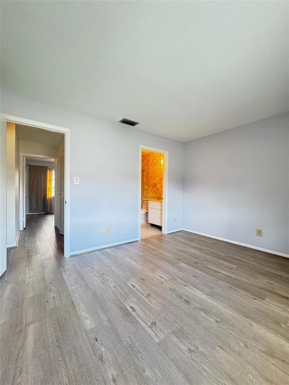 210 Elliot Avenue, Unit 135 Sarasota, FL 34232 - Photo 17 of 26 a view of empty room with wooden floor