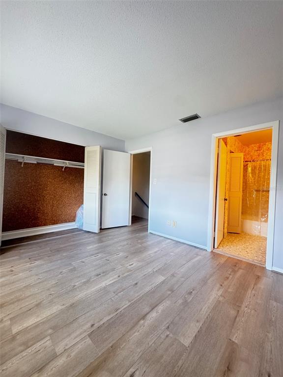210 Elliot Avenue, Unit 135 Sarasota, FL 34232 - Photo 18 of 26 a view of an empty room with wooden floor and a window