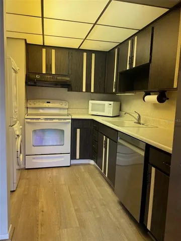 a kitchen with stainless steel appliances a stove a sink and a microwave