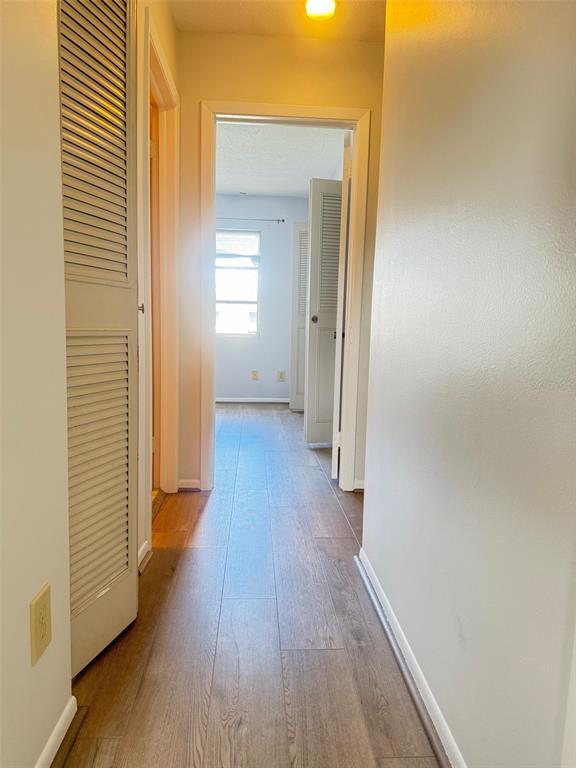 210 Elliot Avenue, Unit 135 Sarasota, FL 34232 - Photo 22 of 26 a view of a hallway with wooden floor