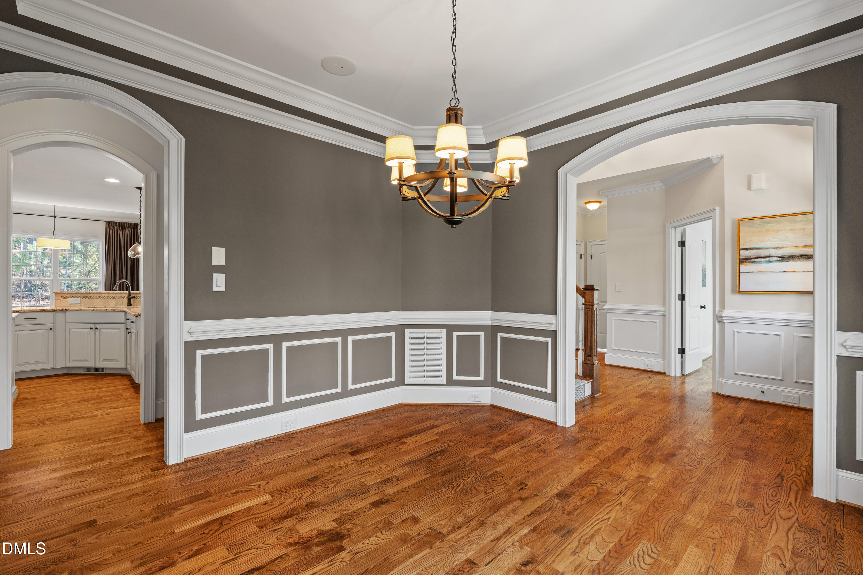 3353 Cheswick Drive Raleigh, NC 27609 - Photo 19 of 53 a view of a livingroom with wooden floor and a kitchen space