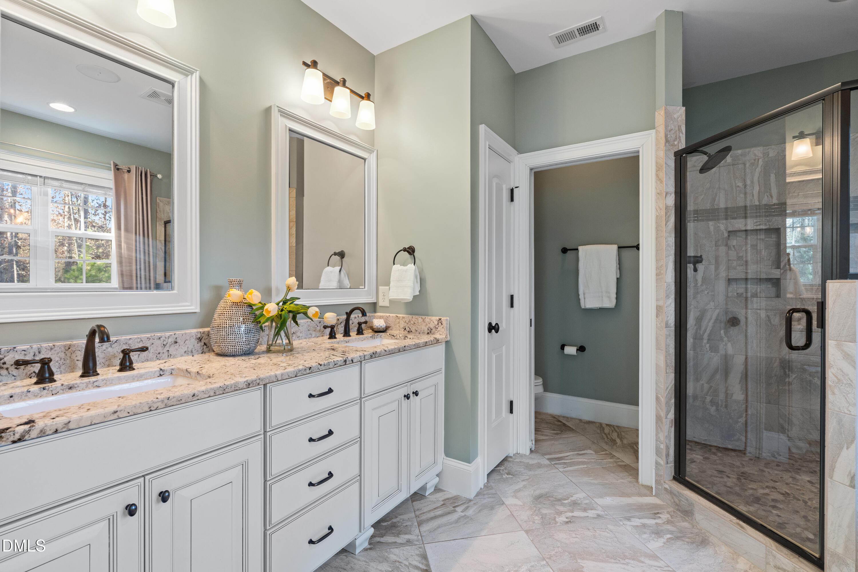 3353 Cheswick Drive Raleigh, NC 27609 - Photo 27 of 53 a spacious bathroom with a granite countertop sink mirror and shower