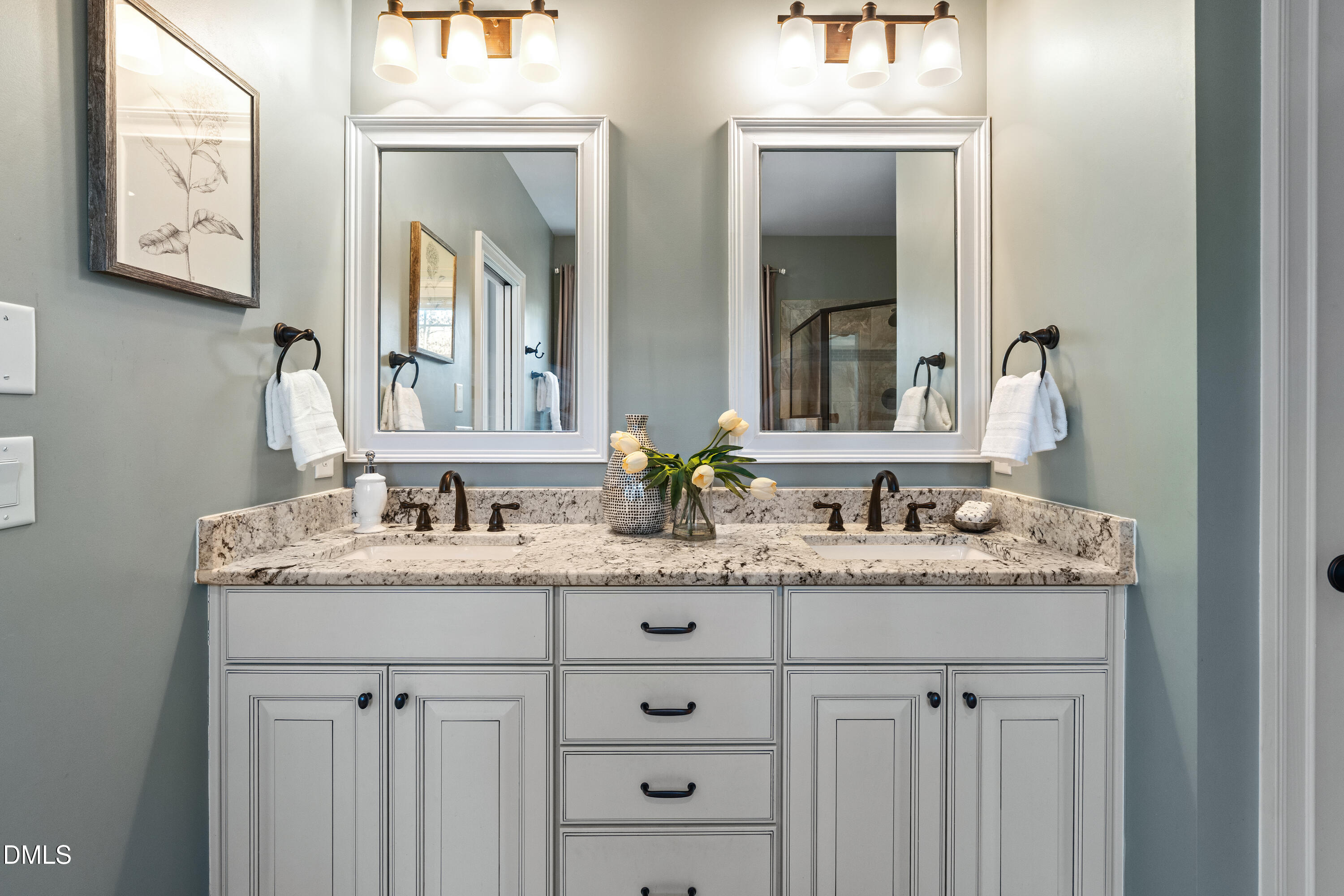 3353 Cheswick Drive Raleigh, NC 27609 - Photo 32 of 53 a bathroom with a granite countertop sink vanity and mirror