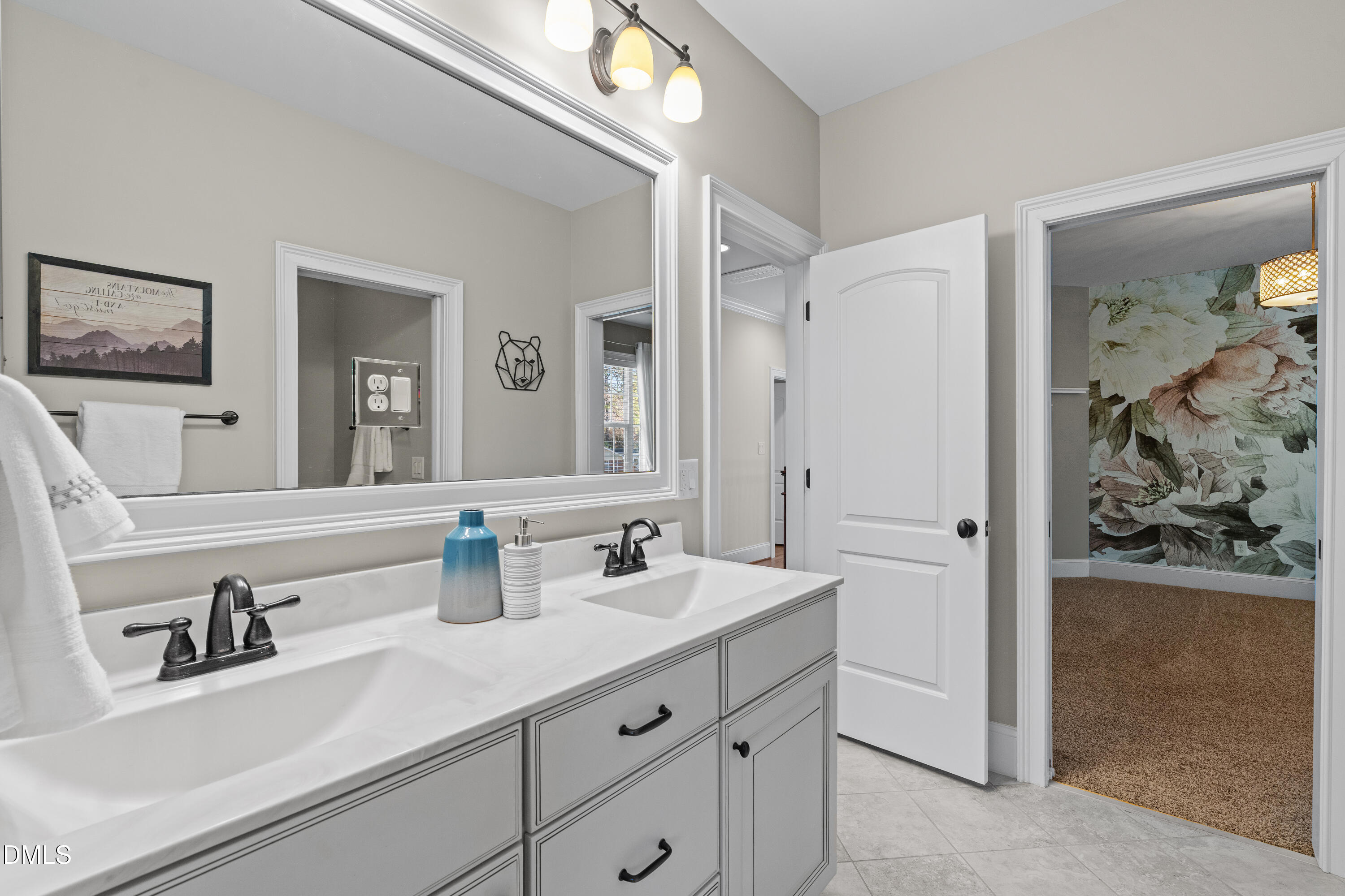 3353 Cheswick Drive Raleigh, NC 27609 - Photo 35 of 53 a bathroom with double vanity sink a mirror and shower