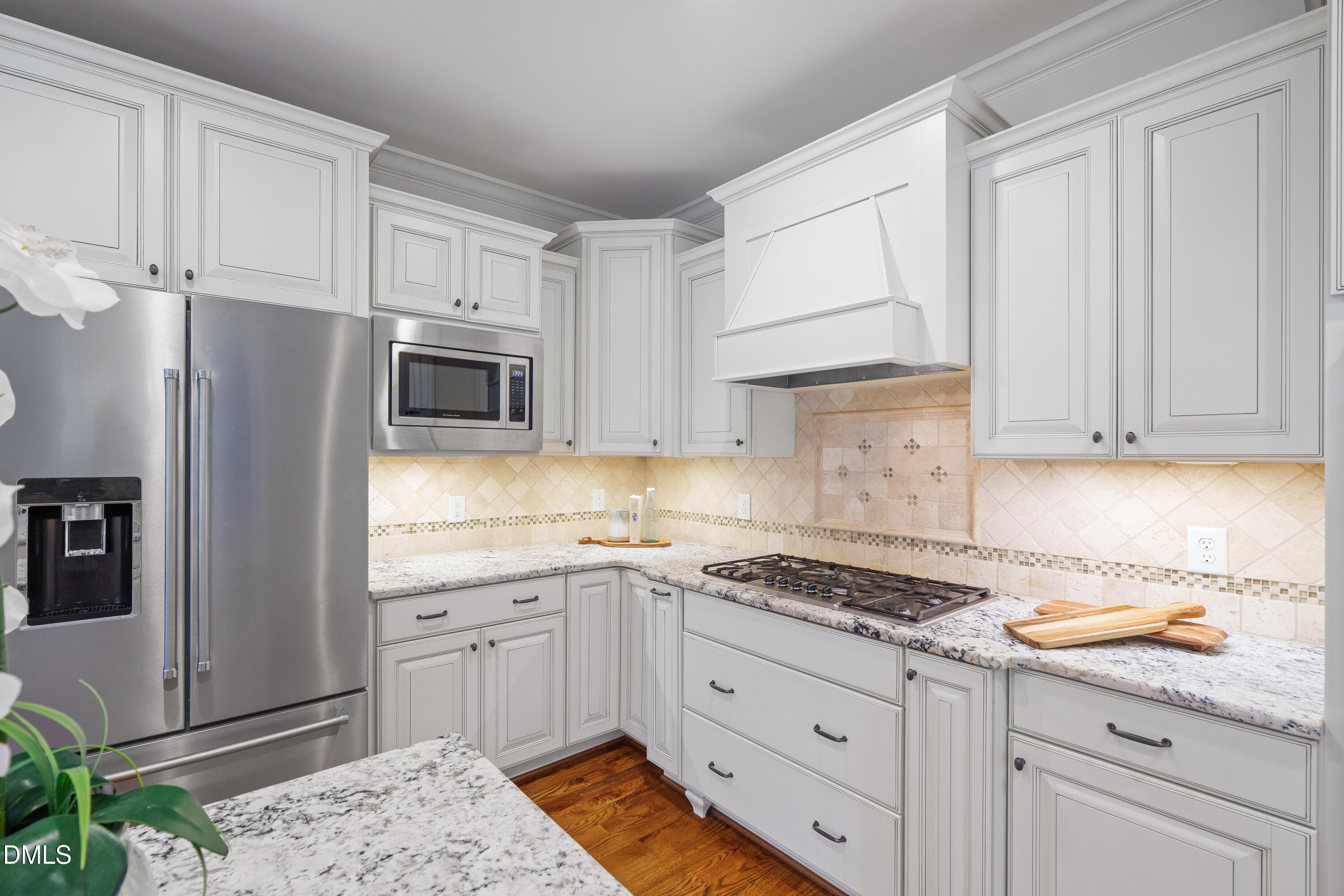 3353 Cheswick Drive Raleigh, NC 27609 - Photo 9 of 53 a kitchen with granite countertop white cabinets and stainless steel appliances