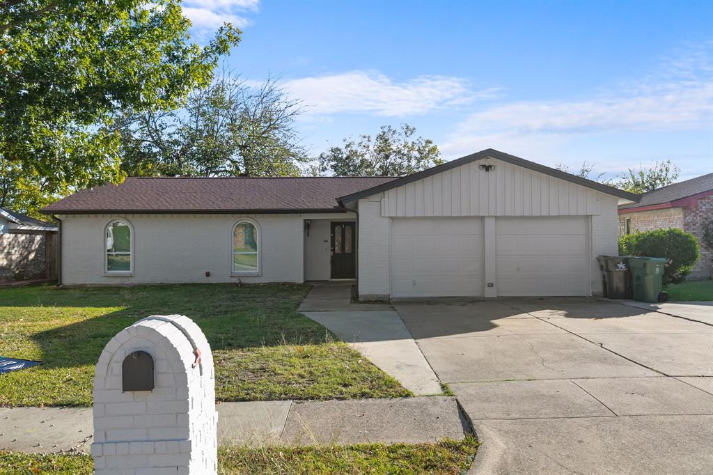 1002 Wembley Road Arlington, TX 76014 - Photo 1 of 20 a front view of a house with garden