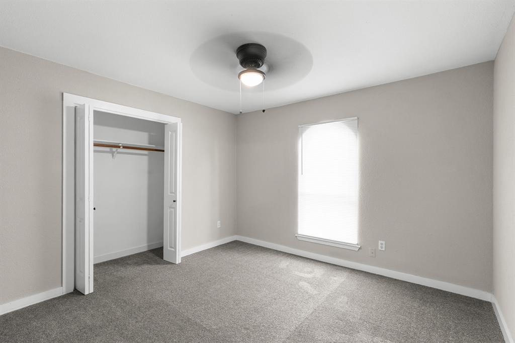 1002 Wembley Road Arlington, TX 76014 - Photo 11 of 20 an empty room with a window and a ceiling fan