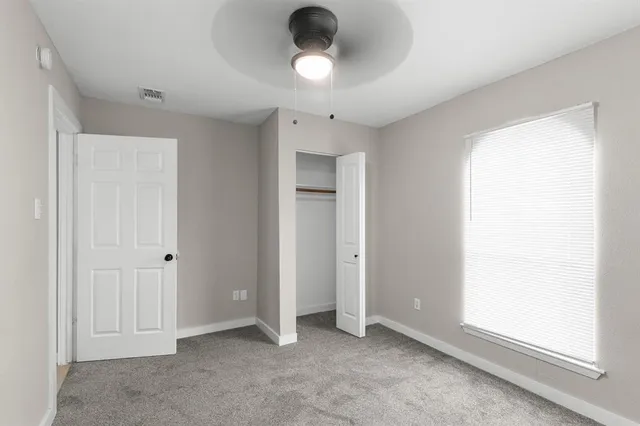 a view of an empty room with a window