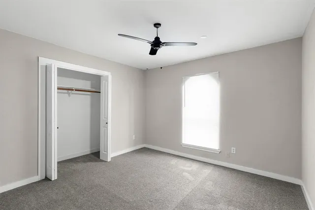 an empty room with windows and cabinet